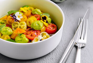 Fresh tomato salad with edible flowers