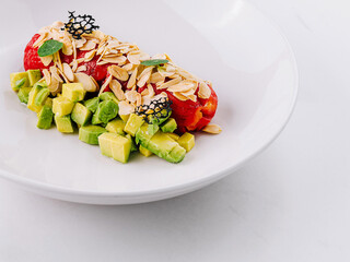 Fresh avocado salad with bell pepper and nuts