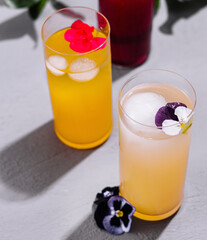Refreshing summer drinks with floral garnish