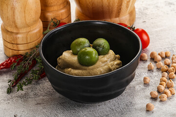 Tasty hummus with green olives