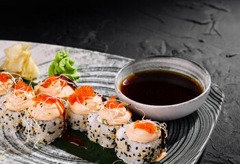 Exquisite sushi roll platter with dipping sauce