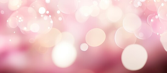 Blurred soft pink background with abstract bokeh lights providing ample copy space image