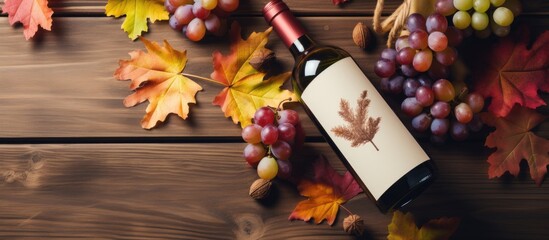 A flat lay image featuring a white wine bottle grapes and autumn leaves with ample copy space