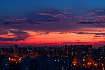 Vibrant and dramatic urban sunset skyline with colorful hues, silhouetted buildings, and panoramic cityscape view at dusk, creating a tranquil and atmospheric mood over the metropolis