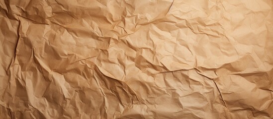 Fototapeta premium A brown crumpled paper with creases serves as a textured background for design and decorative purposes offering a concept of paper textures. Copyspace image
