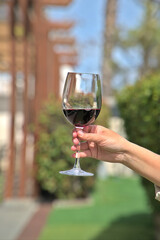 Savoring a Glass of Red Wine Outdoors