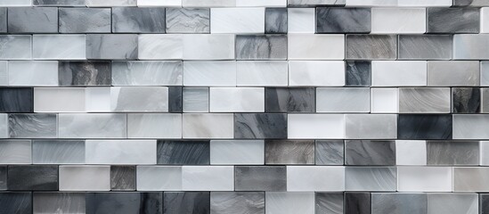 Abstract background of white grey and black ceramic mosaic wall tiles provides a textured and visually appealing option for bathroom decor This top view composition offers ample copy space for additi
