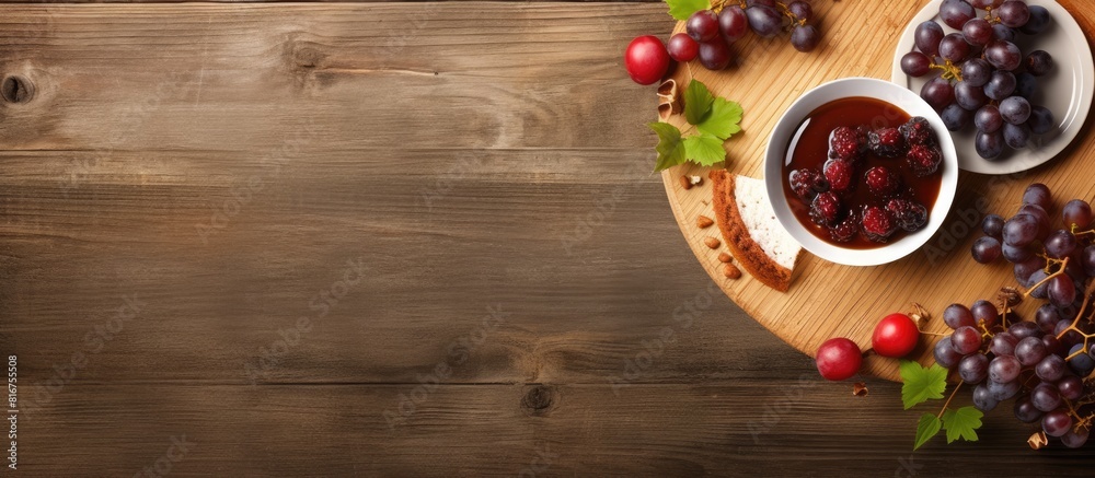 Poster top view of a holiday cake accompanied by a cup of coffee and grapes all placed on a light wooden ba