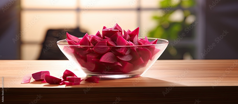 Poster sliced fresh beet in bowl on table. copy space available