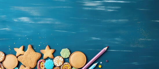 Tasty cookies with shape of school material on a blue wooden background. copy space available