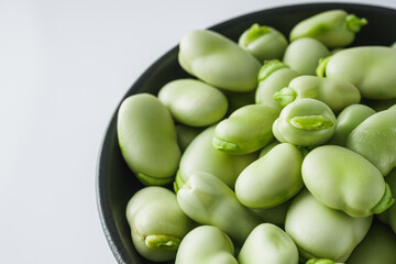 fresh greens broad beans fava on a white background