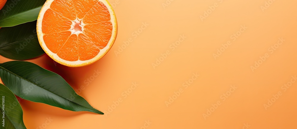 Poster fresh orange fruit with slice and green leaves isolated on orange color background top view flat lay