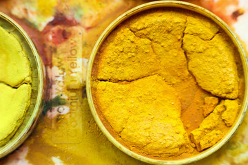 a close up photo of yellow watercolor palette