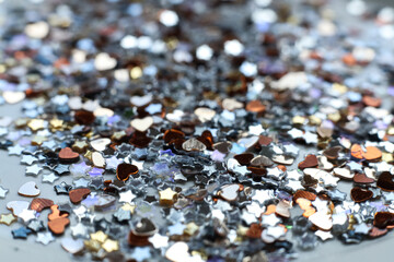 many small shiny sequins on a white background