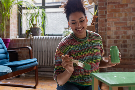 Young adult upcycling a vintage piece of furniture