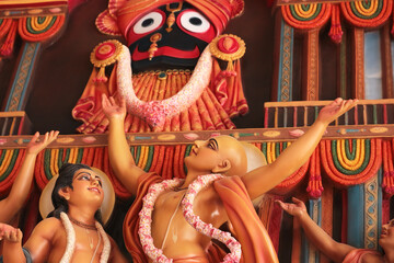 Caitanya Mahaprabhu dances in front of Jagannatha at the Ratha Yatra. Bas-relief in a temple in...