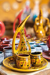 Close-up of a beautifully crafted Cappadocian pottery set, yellow pitcher with intricate designs...