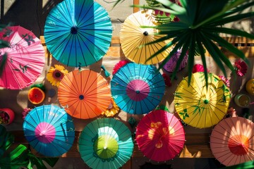 Group of colorful umbrellas hanging neatly on a wall, creating a vibrant and decorative display