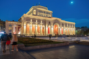 Fototapeta premium Museums of Armenia. Night Yerevan. Building national painting gallery Armenia. Republic square in Yerevan. Architecture south caucasus. Museum building with columns. People walk along streets Yerevan