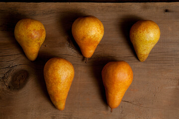 Several pears on wooden background..