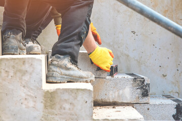 hand of Builder making concrete steps for pedestrian walkway footpath in city. 