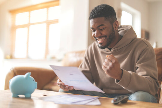 excited man reading letter response to his job application loan mortgage 