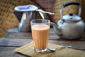 Thai traditional Hot milk tea wooden blackground,