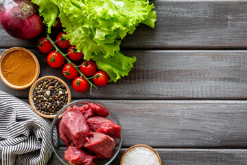 Cooking raw meat with spices and vegetables. Diet food background