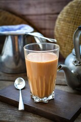 Thai traditional Hot milk tea wooden blackground,