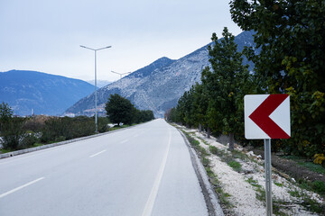 Scenic mountain road with directional sign