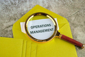 Operations management business concept. OPERATIONS MANAGEMENT written. on paper sticking out of a...