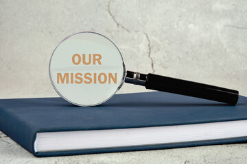 Concept Business and Our Mission concept. Copy space. Word Our Mission through a magnifying glass...