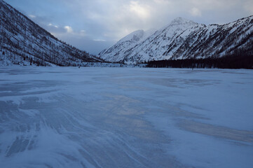 Snow-covered winter mountain lake, Russia, Siberia, Altai mountains.