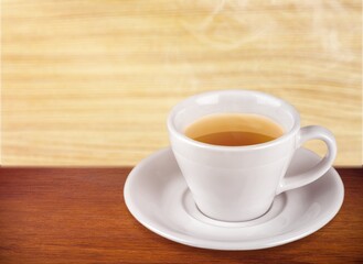 cup of tasty hot green tea on desk background