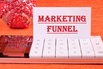 Business concept. Text. words MARKETING FUNNEL on a white business card with a calculator