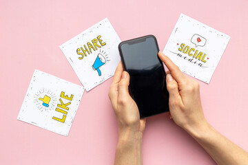 Mobile phone in hands with social media icon. Blogger influencer concept