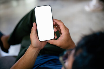cell phone blank white screen mockup.hand holding texting using mobile on desk at office.background...