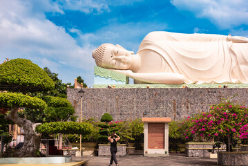 Lying Buddha statue in Vietnam with blue sky