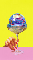 Poster. Contemporary art collage. Female hands reaching to glass of cocktail with disco ball against yellow-pink background. Concept of parties, celebration, holidays, music and dance. Ad