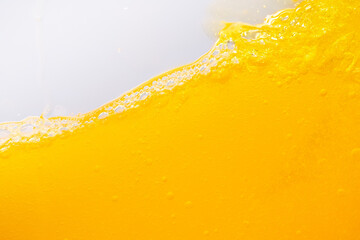 Close up bright orange juice splash texture for health and nature waves, Beautiful waves curve and...