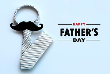 Happy Father's Day. Top view of necktie and false mustache with the text Happy Father's Day