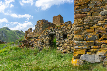 The wall and riuns of Zakagori fortress. Orange lichen on stones