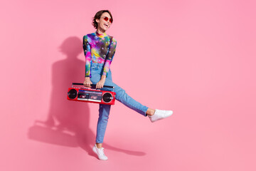Full size photo of nice young woman carry boombox dance wear pullover isolated on pink color background