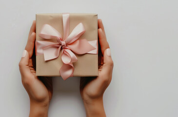 Woman's hands holding a gift box
