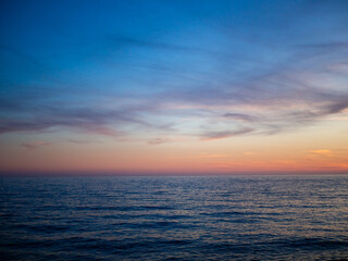 Clear Sky Above the Sea Over the Setting Sun - Calm Pink-Orange Sunset
