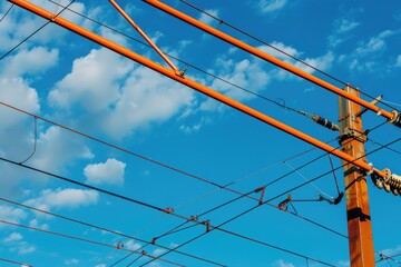 Image of power lines and wires against a clear blue sky. Suitable for energy or technology concepts - Powered by Adobe