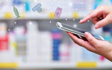 Pharmacist holding mobile phone using for filling prescription in pharmacy drugstore