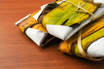 Traditional tempeh wrapped in banana leaves. Tempeh is a traditional Indonesian food made from...
