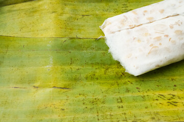 Traditional tempeh wrapped in banana leaves. Tempeh is a traditional Indonesian food made from...