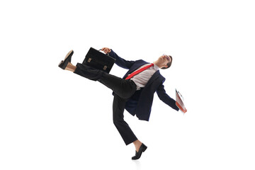 Fototapeta premium Motivated businessman, worker in formal wear with briefcase and documents walking to work isolated on white background. Concept of business, office lifestyle, employment. Dynamic pose